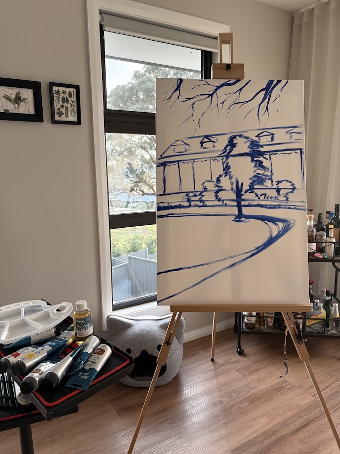 A canvas with some blue lines painted on it to sketch out the composition.