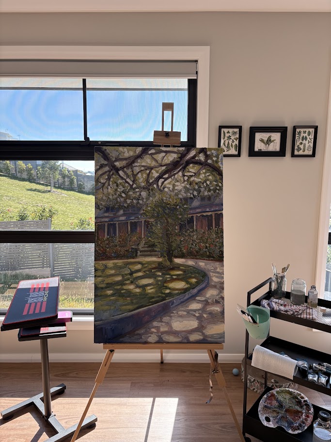 Photo of a landscape oil painting on an easal.